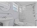 Clean bathroom with a stand-up shower, pedestal sink, modern fixtures, and good natural light at 155 Patty Ann Blvd, Palm Harbor, FL 34683