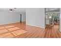 Bright and airy living room featuring wood-look floors and neutral wall paint at 155 Patty Ann Blvd, Palm Harbor, FL 34683