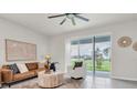 Bright living room with sliding glass doors leading to the backyard and water view at 16177 Glowing Grove Ave, Odessa, FL 33556