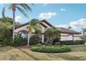 Charming single-story home with well-manicured landscaping, mature palms, and inviting curb appeal at 1641 Bayfield Ct, Trinity, FL 34655