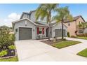 Charming home with a three-car garage, mature landscaping, and symmetrical curb appeal at 1771 Whitewillow Dr, Wesley Chapel, FL 33543