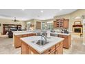A kitchen featuring an island sink with an open concept design and lots of natural light at 18328 Treehaven Dr, Hudson, FL 34667