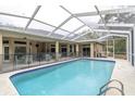 Screened-in pool with a safety fence, offering a private outdoor space with a covered lanai at 18328 Treehaven Dr, Hudson, FL 34667
