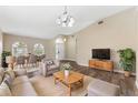 Spacious living room with dining area featuring hardwood floors, neutral colors, and ample natural light at 18456 Merseyside Loop, Land O Lakes, FL 34638