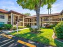 Exterior of the building with parking spot, sidewalks, lush landscaping, and a tranquil atmosphere at 2410 Hammock Pine Blvd # 2410, Clearwater, FL 33761