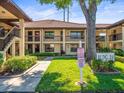 Exterior of a building with beautiful landscaping, sidewalks, and a spacious yard at 2410 Hammock Pine Blvd # 2410, Clearwater, FL 33761