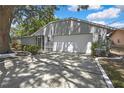 The home features a two-car garage and manicured landscaping, creating an inviting exterior at 279 Maple Ave, Palm Harbor, FL 34684