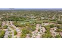 Aerial view of a residential community, golf course, and surrounding lush landscape with the Gulf in the distance at 3013 Appleblossom Trl, Spring Hill, FL 34606