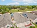 A high angle view of this beautiful home featuring a large backyard, a screen enclosed pool, and well manicured lawn at 305 Royal Palm Way, Spring Hill, FL 34608