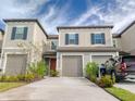 Charming townhome boasts a front-entry garage and beautifully landscaped front yard at 31718 Blue Passing Loop, Wesley Chapel, FL 33545