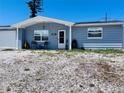 Charming single story home featuring a covered porch area and rock landscaping at 3309 Bayport Dr, Holiday, FL 34691