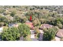 An aerial view showcasing the home's lot, surrounding trees, and a private pool area at 4475 Rachel Blvd, Spring Hill, FL 34607