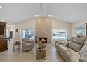 Inviting living room boasts a cozy fireplace, comfortable seating, and picturesque water views from large windows at 5033 Cabrilla Ct, New Port Richey, FL 34652