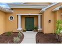 Inviting front entryway with elegant pillars, a double door, and attractive landscaping at 5110 Championship Cup Ln, Spring Hill, FL 34609