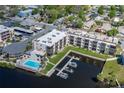 Aerial view of the Rivermist Condominiums with waterfront access, boat docks, and community pool at 5640 Ferguson Ct # 2106, New Port Richey, FL 34652