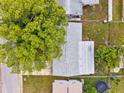 Aerial view of the home and roof showing the layout and surroundings at 5706 Mockingbird Dr, New Port Richey, FL 34652