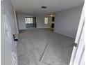 Spacious living room featuring new carpeting and neutral paint at 5949 1St Ave, New Port Richey, FL 34652