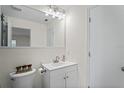 Clean bathroom featuring a modern vanity, a large mirror, and a toilet at 6047 Elmhurst Dr # 5A, New Port Richey, FL 34653