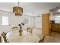 Open-concept dining room with a large table and views of the adjoining living areas at 6047 Elmhurst Dr # 5A, New Port Richey, FL 34653