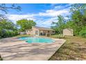 Relaxing backyard oasis with a refreshing swimming pool and ample space for outdoor lounging and entertaining at 6104 Cork Ct, New Port Richey, FL 34653