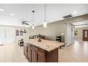 Open-concept kitchen featuring a center island, recessed lighting, and seamless flow to the living area at 6104 Cork Ct, New Port Richey, FL 34653