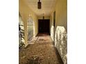 Inviting front porch features mosaic tile flooring, arched entryway, and lantern-style lighting at 8711 Cutlass Dr, Hudson, FL 34667