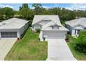 Bright single-story home featuring a lovely tiled roof and mature trees at 9147 Rhett Ln, Weeki Wachee, FL 34613