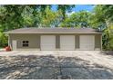 Spacious three-car garage with ample parking space on a concrete pad, perfect for car enthusiasts or storage at 10645 Fawn Dr, New Port Richey, FL 34654