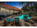 Inviting outdoor space with pool, seating and lush landscaping, perfect for entertaining at 10712 Pontofino Cir, Trinity, FL 34655
