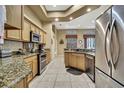 Well-lit kitchen featuring granite countertops, stainless steel appliances, and custom cabinetry at 11253 Avalon Way, Spring Hill, FL 34609