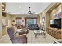 Open-concept living room featuring tile floors, ceiling fan, and neutral-toned walls at 11253 Avalon Way, Spring Hill, FL 34609