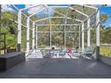 Outdoor patio with screen enclosure, offering ample space for seating and entertaining at 11253 Avalon Way, Spring Hill, FL 34609