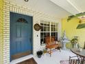 Inviting porch with seating, a fountain, and decorative plants near the entryway at 11630 Pasadena Rd, Dade City, FL 33525