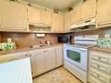 Efficient kitchen features a microwave, stove, and plenty of storage space at 11814 Carissa Ln, New Port Richey, FL 34654