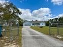 A nice single-story light blue home with a screened garage and front porch at 13377 Montour St, Brooksville, FL 34613