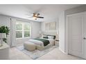 Comfortable bedroom with large window, neutral color scheme, bench, and stylish decor at 3032 Jacob Crossing Ln, Holiday, FL 34691