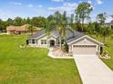 Charming single-story home features a well-manicured lawn and attached two-car garage at 3455 Whispy Ct, Spring Hill, FL 34609