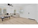 Bright living room with natural light, neutral tones and light wood flooring at 4035 Fairfield S Ave, St Petersburg, FL 33711