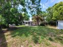Expansive backyard with mature trees and privacy, perfect for outdoor relaxation at 4118 Flamingo Dr, New Port Richey, FL 34652