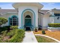 Charming home entrance featuring decorative double doors and beautifully landscaped surroundings at 473 Tournament Dr, Spring Hill, FL 34608