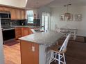 Spacious eat-in kitchen featuring an island with granite countertops and stainless steel appliances at 5045 Musselshell Dr, New Port Richey, FL 34655