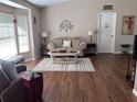 Cozy living room with hardwood floors, neutral paint, and great natural light at 5045 Musselshell Dr, New Port Richey, FL 34655