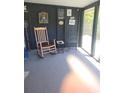 Relaxing porch with rocking chair and black decor, perfect for enjoying the outdoors at 6507 Ginny Dr, Port Richey, FL 34668