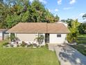 Charming single-story home featuring a well-manicured lawn and nicely landscaped front yard at 7101 N 18Th St, Tampa, FL 33610