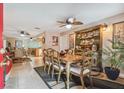 Formal dining room featuring a ceiling fan, hutch, and tiled flooring at 7427 Baltusrol Dr, New Port Richey, FL 34654