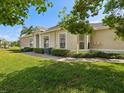 Side view of a single-story home boasting a well-manicured lawn and meticulous landscaping at 7427 Wimpole Dr # 7427, New Port Richey, FL 34655