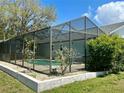 Inviting screened-in pool with a beautiful outdoor setting and plenty of space for lounging and entertaining at 7444 Candlelight Ct, New Port Richey, FL 34652