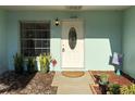 Charming home entrance with decorative door, plants, and flower, creating a welcoming curb appeal at 11648 Boynton Ln # 39Gb, New Port Richey, FL 34654
