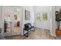 Inviting entryway with neutral paint, decorative bench and artwork, and tile floors at 11730 Hawks Nest Trl, Brooksville, FL 34614