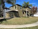 Attractive two-story home with a well-maintained lawn, attached garage and tidy landscaping at 11796 Crestridge Loop, New Port Richey, FL 34655